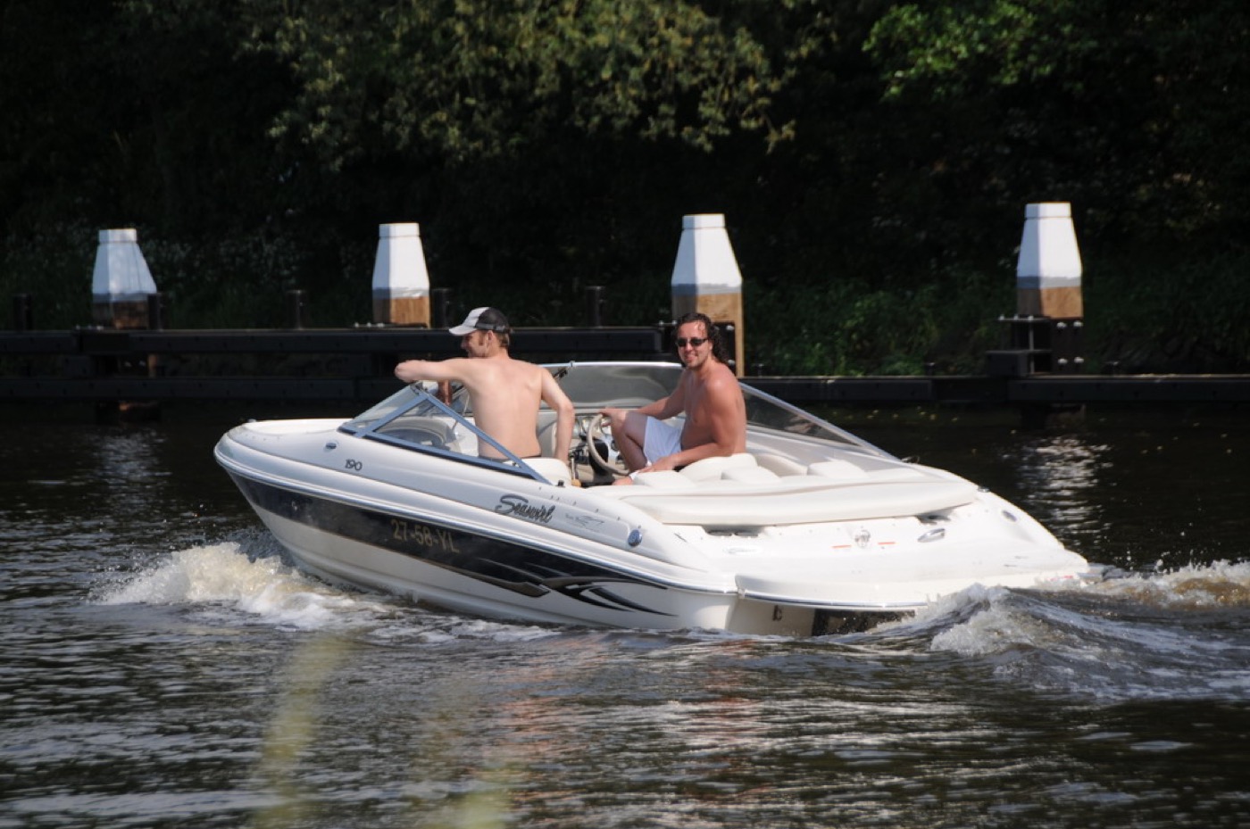Family cruising on a bowrider boat on a sunny lake